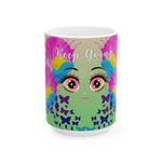 Mug with colorful design of a face and butterflies, featuring the text 'Keep Going'.