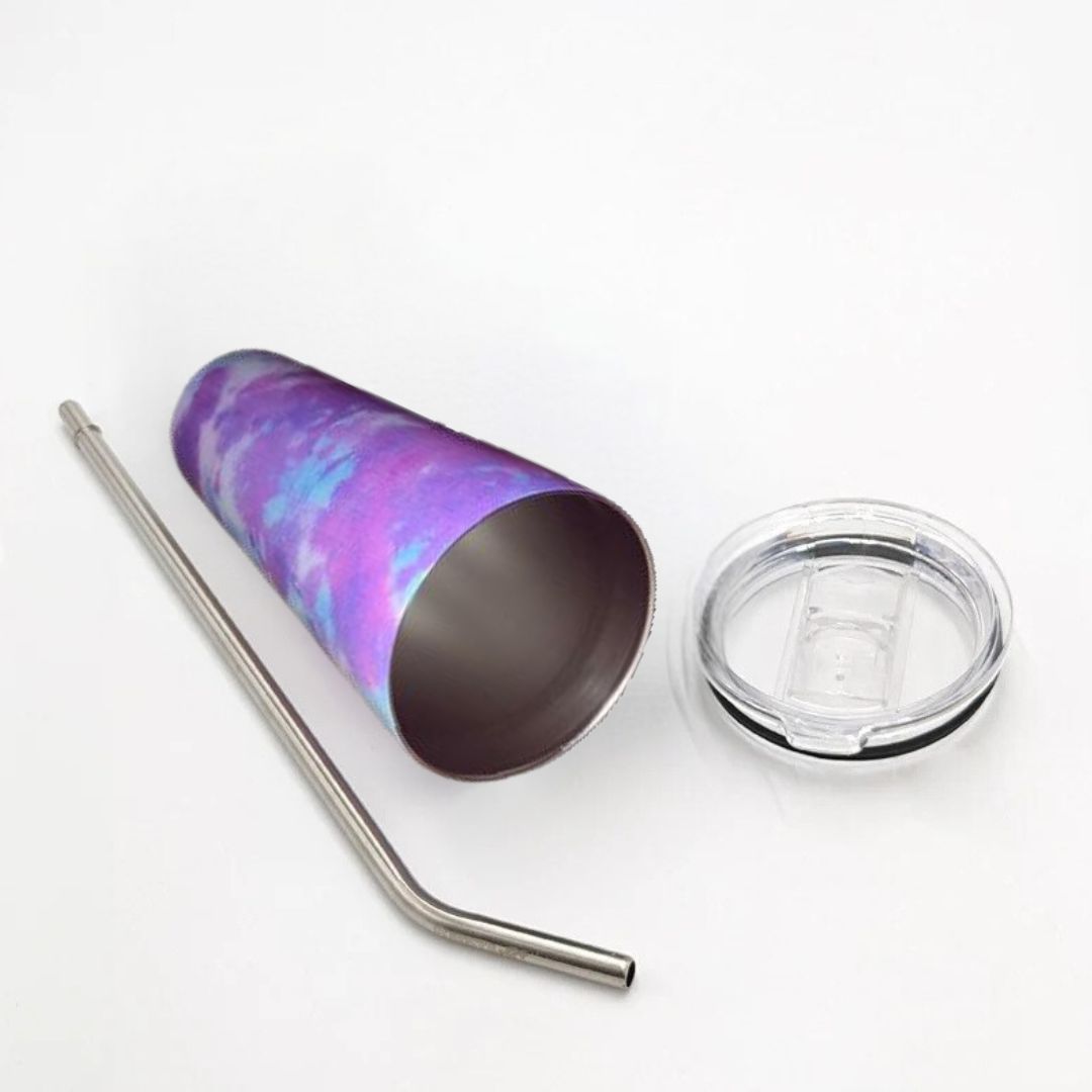Stainless steel tumbler with a colorful pattern, metal straw, and clear lid on a white background