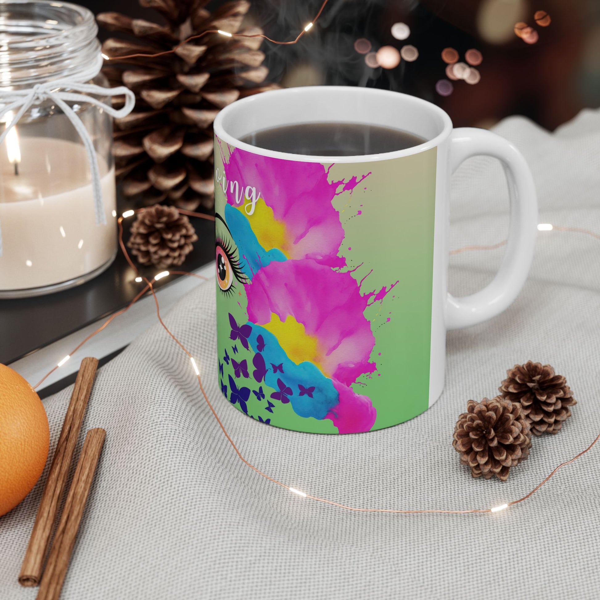 Colorful mug with artistic design on a table with decorative items